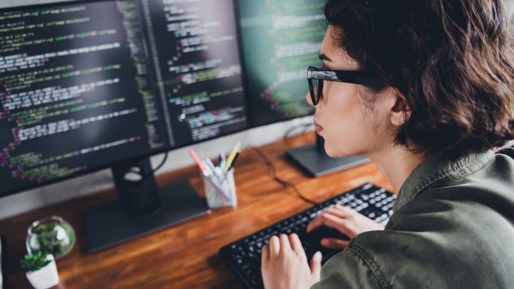 Female software programmer working at a computer.